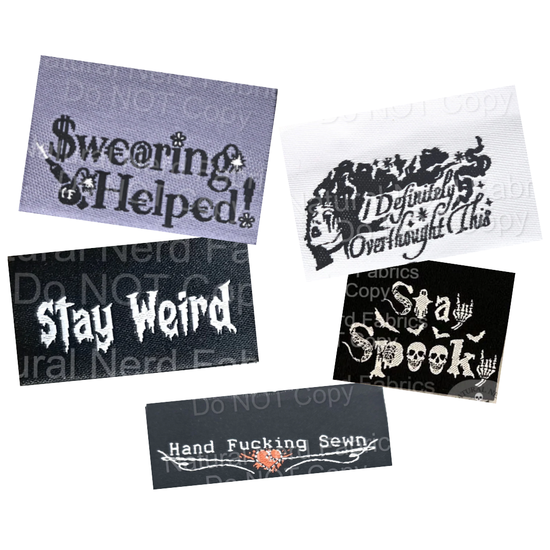 Set of woven fabric sew-in labels on a white background.